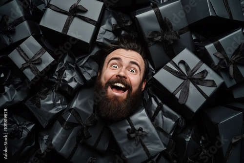 an funny image with in the center a beautiful smiling man buried under lot of black gifts, black friday concept