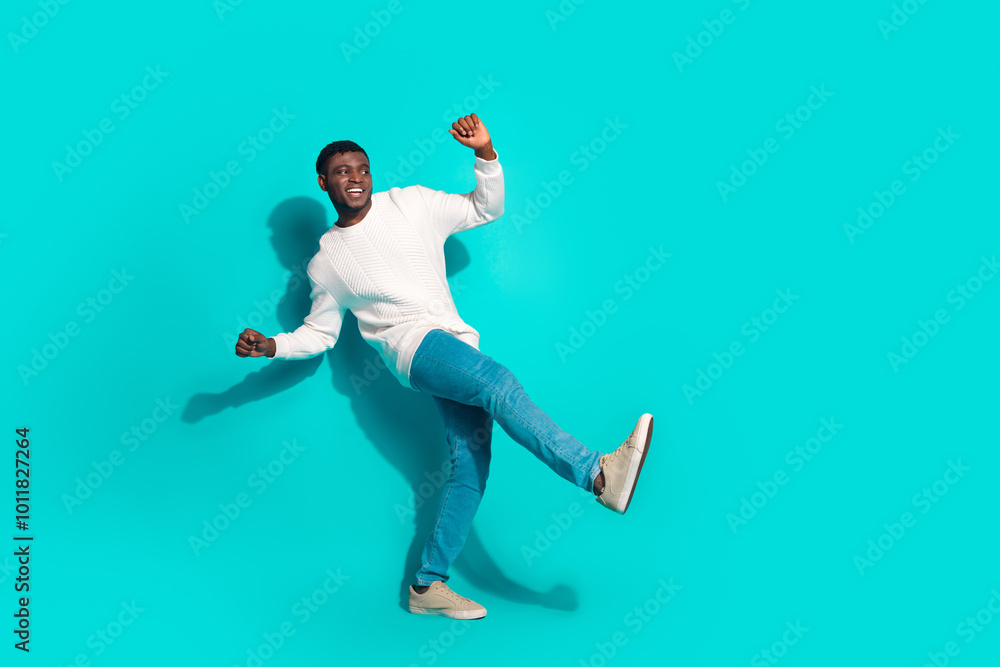 Full body photo of attractive young man dance have fun dressed stylish white clothes isolated on cyan color background Full body photo of attractive young man dance have fun dressed stylish white clothes isolated on cyan color background