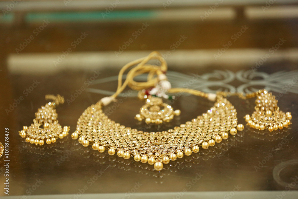 A beautiful gold jewelry set featuring an intricately designed necklace, earrings, and a pendant with a traditional touch. A beautiful gold jewelry set featuring an intricately designed necklace, earrings, and a pendant with a traditional touch.