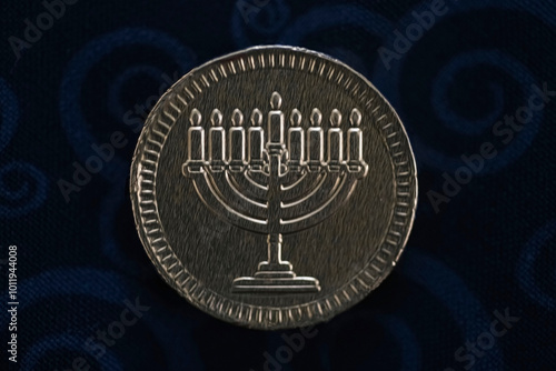 Coins in hanukkah celebration as hebrew tradition, on dark background. photo