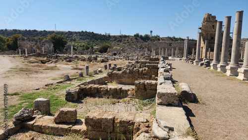 The shops ruins by the side of a colonnaded main street in the agora in Perge ancient city located in Aksu district of Antalya province in Turkey photo