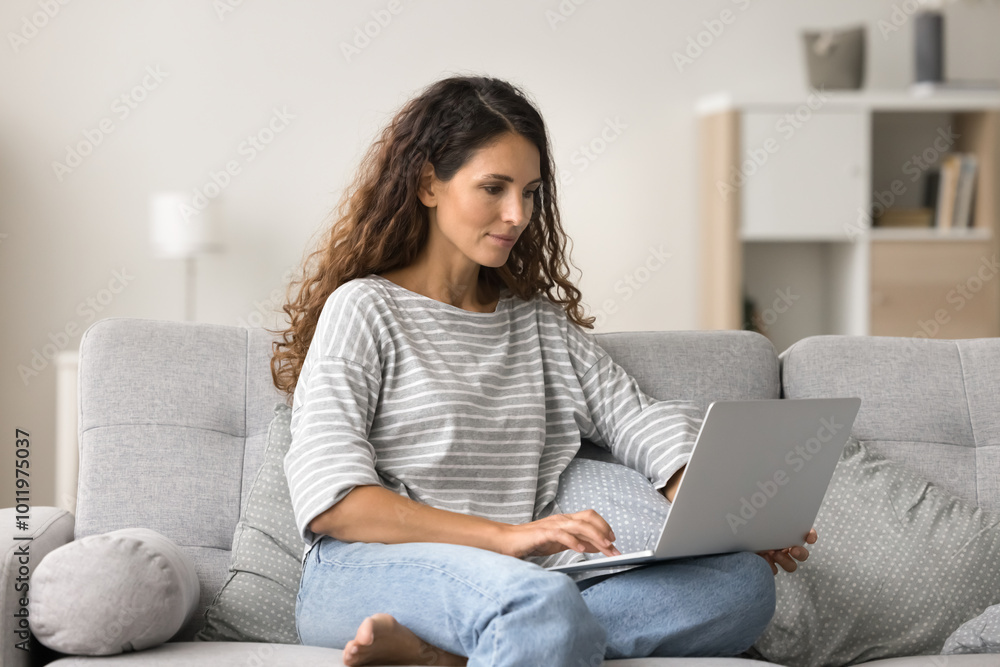 Positive pretty young woman using online service, application on laptop for communication, enjoying domestic Internet technology, working on freelance business project at home Positive pretty young woman using online service, application on laptop for communication, enjoying domestic Internet technology, working on freelance business project at home