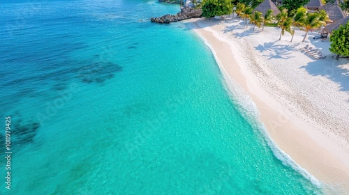 A photostock image of a luxurious beachfront resort with white sand, palm trees, and turquoise water