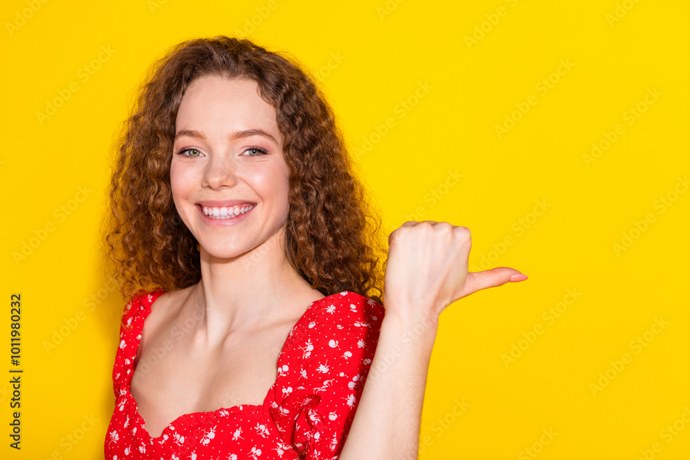 Photo portrait of lovely young lady point empty space dressed stylish red garment isolated on yellow color background Photo portrait of lovely young lady point empty space dressed stylish red garment isolated on yellow color background