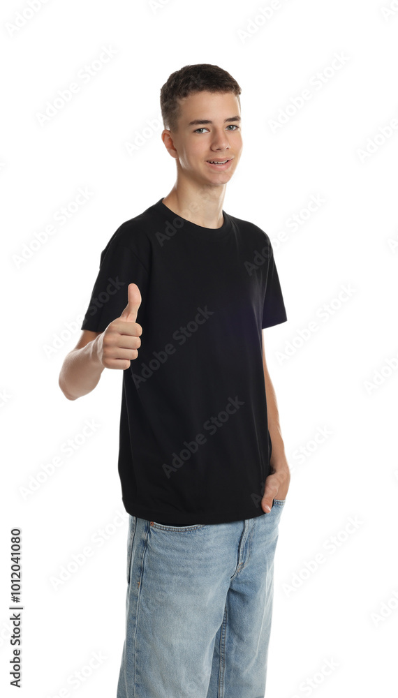 Teenage boy wearing black t-shirt and showing thumbs up on white background Teenage boy wearing black t-shirt and showing thumbs up on white background