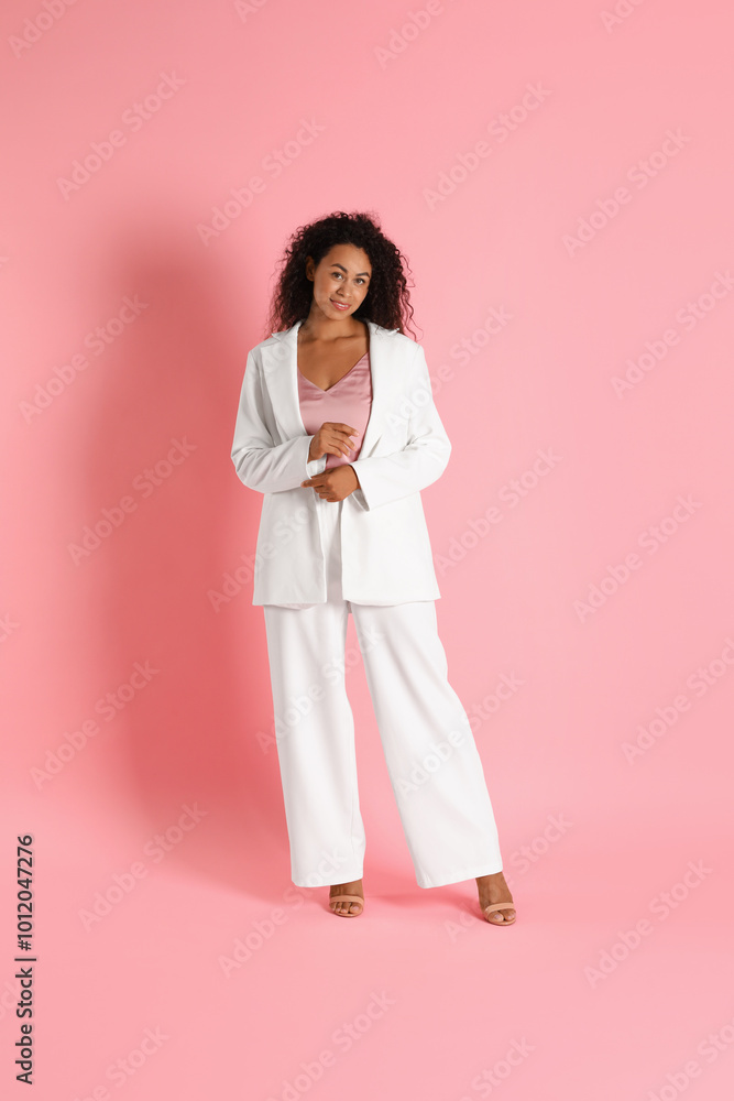 Beautiful woman in stylish suit on pink background Beautiful woman in stylish suit on pink background