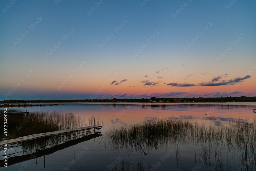 Wooden Dock Overlook the Tranquil Sunset Waters of Lake Huron, Ontario, Canada. Quiet Late Summer Lakeside Sunset Wooden Dock Overlook the Tranquil Sunset Waters of Lake Huron, Ontario, Canada. Quiet Late Summer Lakeside Sunset