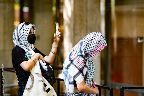 Bild auf Leinwand Two NYU or New School student anti-Israel protesters disguised with medical mask