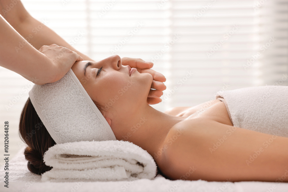 Attractive woman enjoying face massage in spa salon Attractive woman enjoying face massage in spa salon