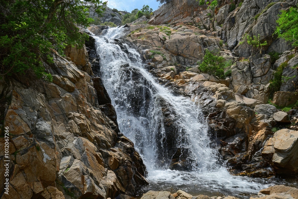 A serene waterfall cascades down rocky cliffs surrounded by lush greenery in a peaceful natural setting during daylight hours A serene waterfall cascades down rocky cliffs surrounded by lush greenery in a peaceful natural setting during daylight hours
