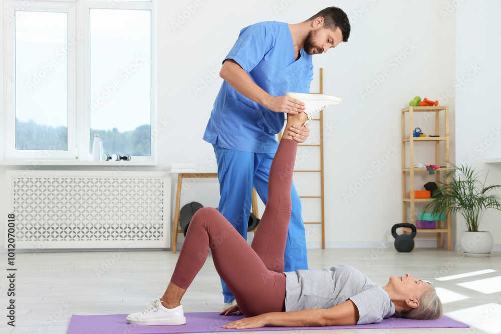 Physiotherapist working with senior patient in rehabilitation center Physiotherapist working with senior patient in rehabilitation center