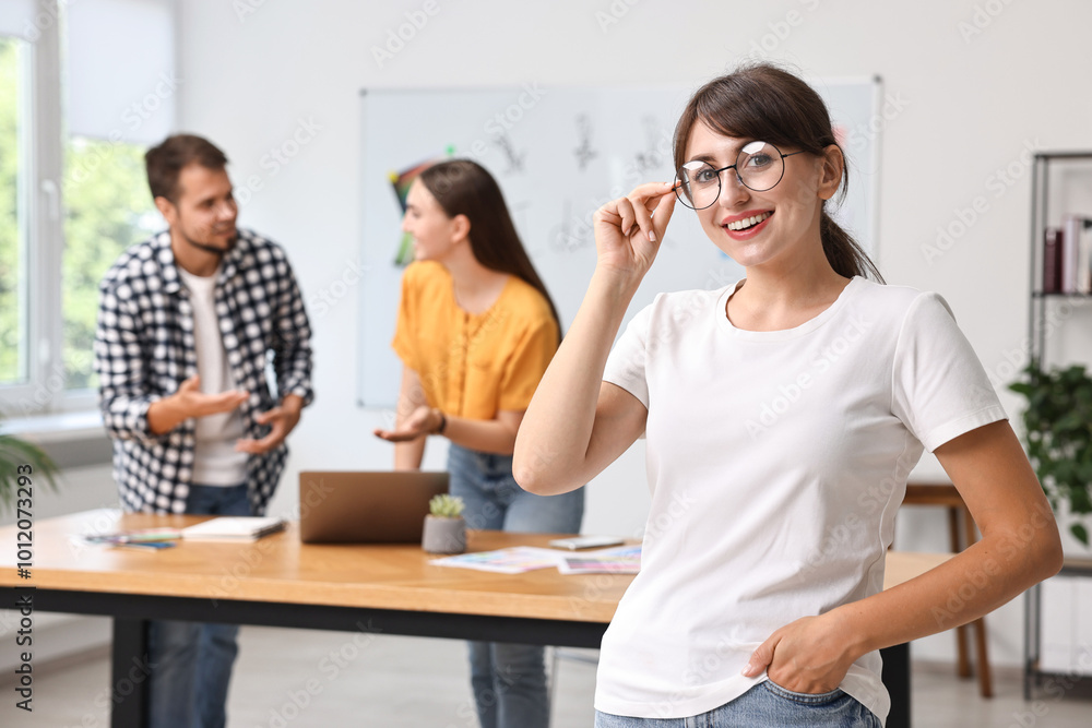 Happy young designer with glasses in office Happy young designer with glasses in office