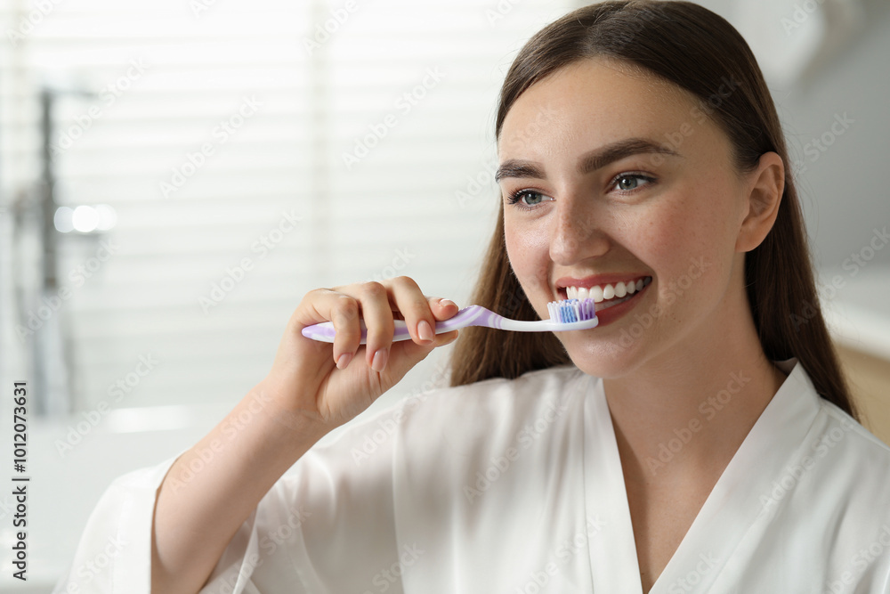 Beautiful woman brushing her teeth in bathroom Beautiful woman brushing her teeth in bathroom