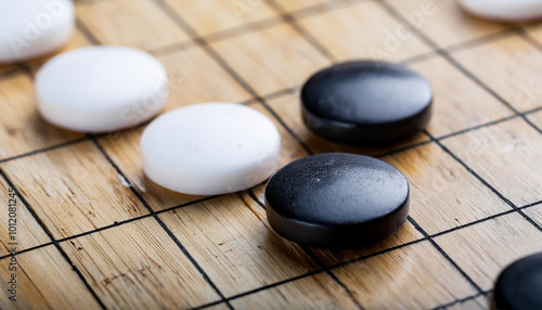 White and black round stones for Korean board game Go. Wei-chi, Chinese game. Patok or Baduk. photo