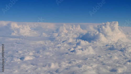 Towers of massive white clouds viewed from airplane