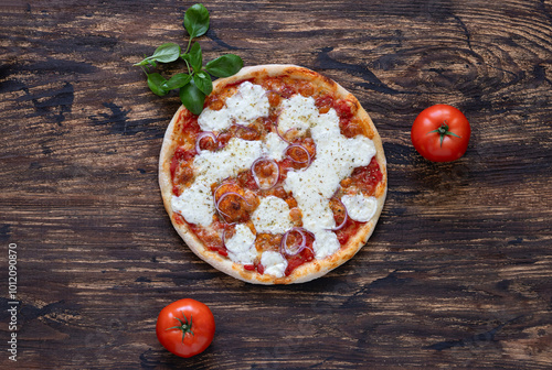 Pizza with tomato sauce, mozzarella cheese, red onion and fresh basil on wooden background. Top view. Copy space