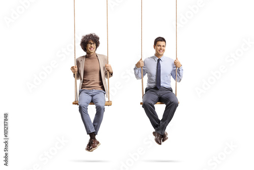 Colleagues having fun and sitting on swings