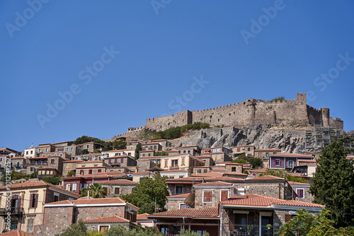 Historic houses and castle on top of a hill in Molyvos on the island of Lesbos photo