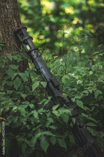 Prop gun leaning on tree