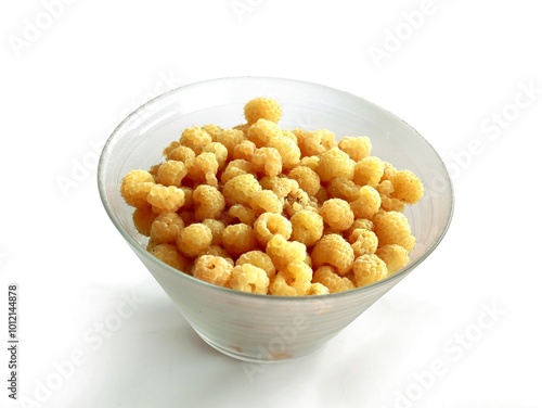 yellow raspberries in glass pot close up