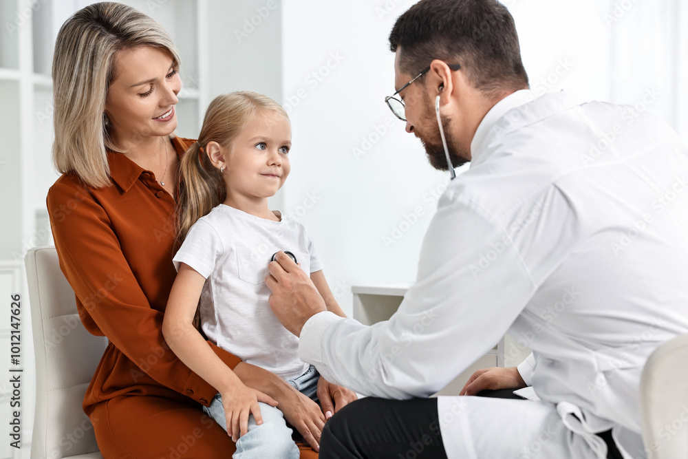 Doctor examining little girl with stethoscope and her mother in hospital Doctor examining little girl with stethoscope and her mother in hospital