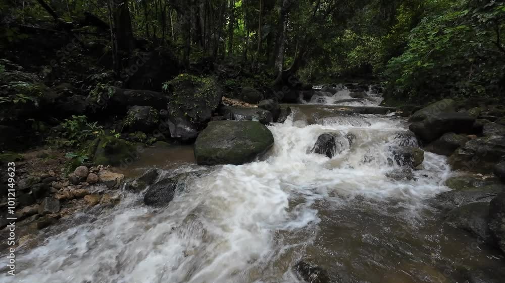 Waterfall in the rainy season has muddy red water flowing rapidly. Waterfall in the rainy season has muddy red water flowing rapidly.