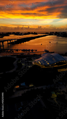 sunset photo from drone above, sunset with ocean in background, road goes into sunset