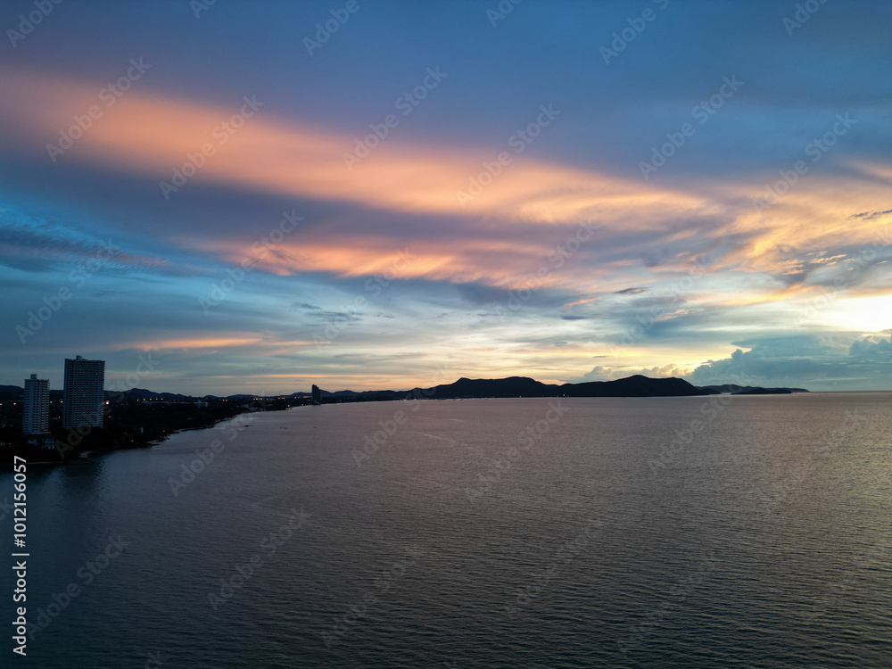 Naklejka premium 컬러풀한 노을과 함께하는 태국 파타야 남부의 나좀티엔 해변과 선착장, 방파제