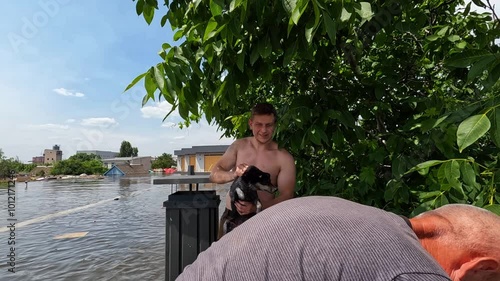 Volunteer rescue scared and skinny dog after detonation of Kakhovka Hydroelectric Power Station. Consequences of the detonation of dam on Dnipro river in Kherson town. Slow motion photo