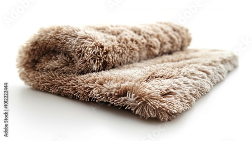 Beige carpet is rolled up showing its texture and edge binding