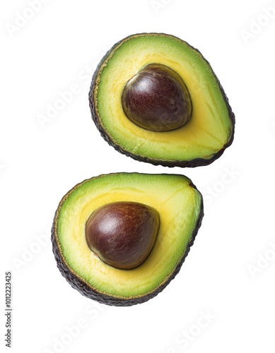 Ripe avocados cut open to reveal creamy interior and seed on a white background