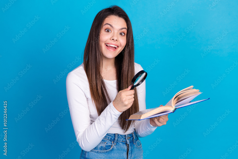 Photo portrait of lovely teen lady magnifier loupe read book dressed stylish white garment isolated on blue color background Photo portrait of lovely teen lady magnifier loupe read book dressed stylish white garment isolated on blue color background
