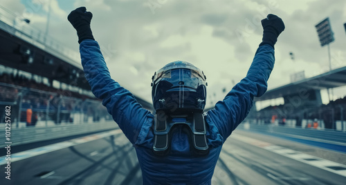 race car driver celebrates victory with arms raised, capturing the excitement, adrenaline, and triumph of motorsport formula one competition photo