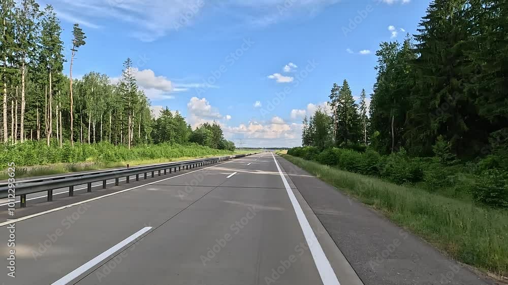 Road view on a summer day. Highways, roadside and white road line markings. Road view on a summer day. Highways, roadside and white road line markings.