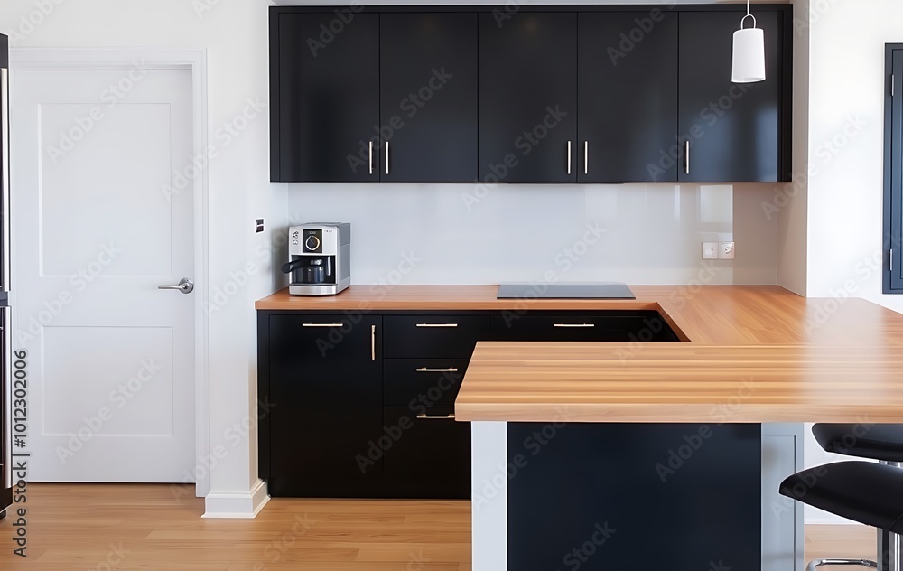 Modern kitchen interior with bar counter, black cabinets and wooden countertop. A coffee machine stands on one side of it. Modern kitchen interior with bar counter, black cabinets and wooden countertop. A coffee machine stands on one side of it.