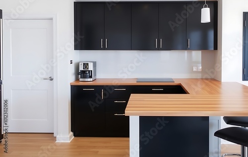 Modern kitchen interior with bar counter, black cabinets and wooden countertop. A coffee machine stands on one side of it. 