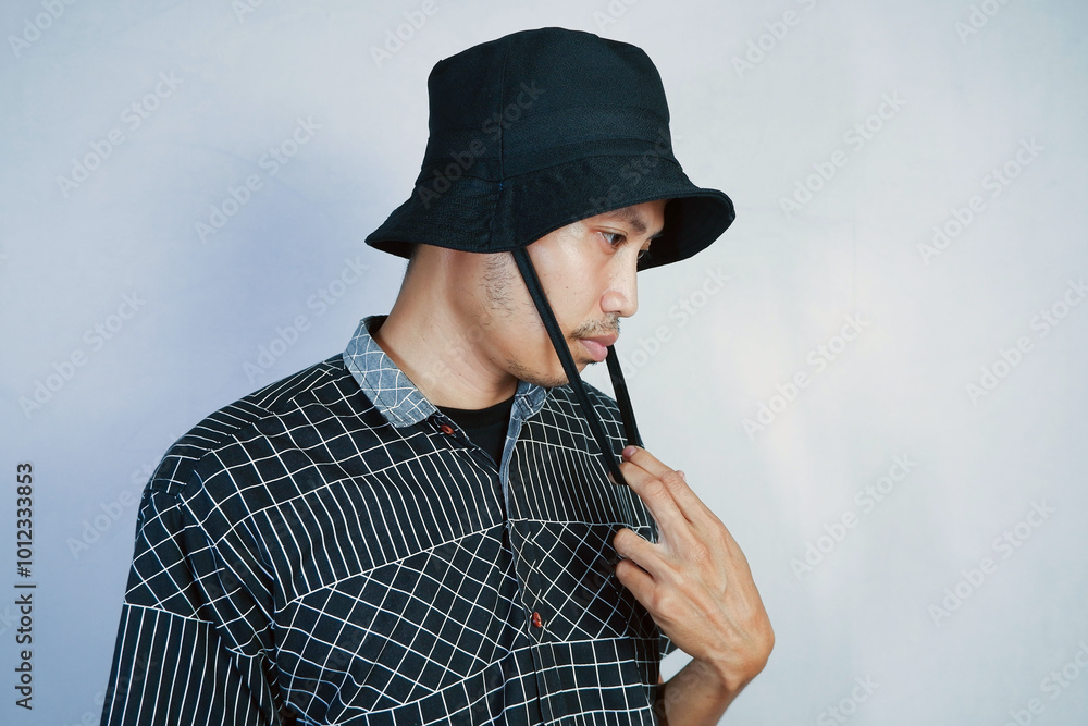 man posing wearing a black bucket hat. isolated white background man posing wearing a black bucket hat. isolated white background