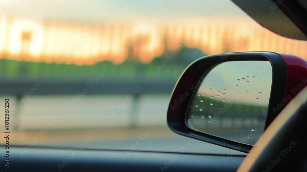 Video shooting in motion, view in the rear view side mirror of a auto, driving a red car along the road Video shooting in motion, view in the rear view side mirror of a auto, driving a red car along the road