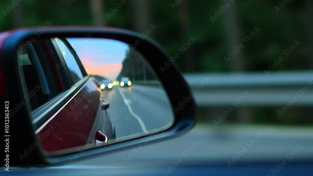 Video shooting in motion, view in the rear view side mirror of a auto, driving a red car along the road Video shooting in motion, view in the rear view side mirror of a auto, driving a red car along the road
