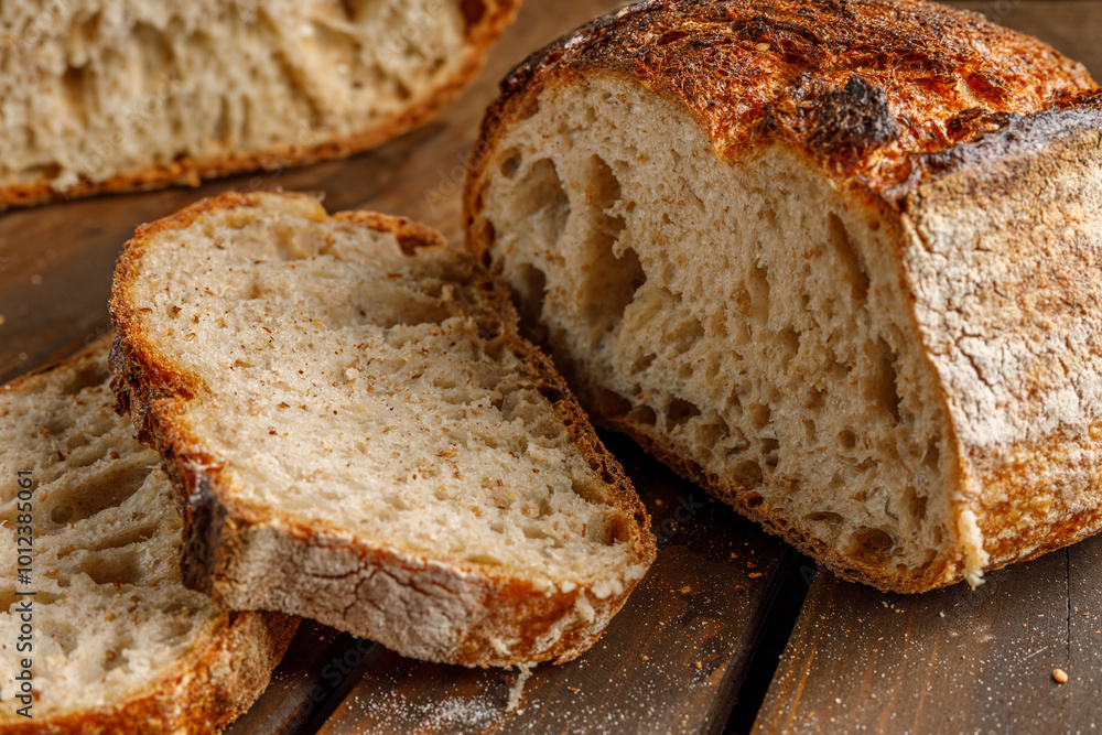 The freshly baked artisanal bread is elegantly and beautifully displayed on a charming rustic wooden surface The freshly baked artisanal bread is elegantly and beautifully displayed on a charming rustic wooden surface
