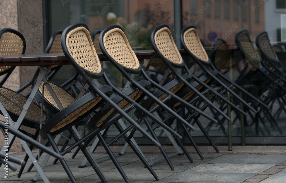 Naklejka premium Dining chairs turned over in a closed restaurant near Christiania Torv - 2