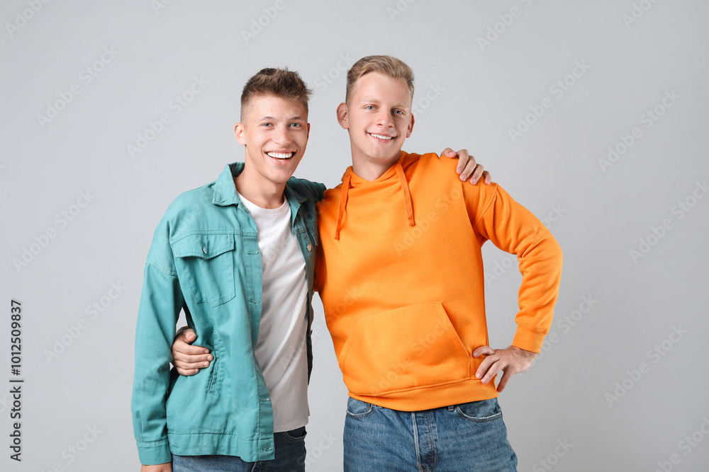 Portrait of two happy brothers on light background Portrait of two happy brothers on light background