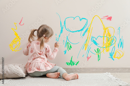 Quadro em tela Little child drawing on white wall, back view