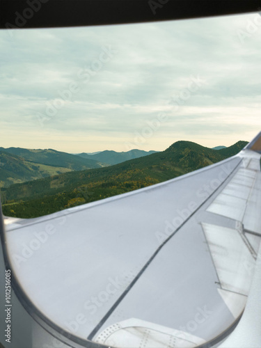 Airplane flying over mountains, beautiful view from window