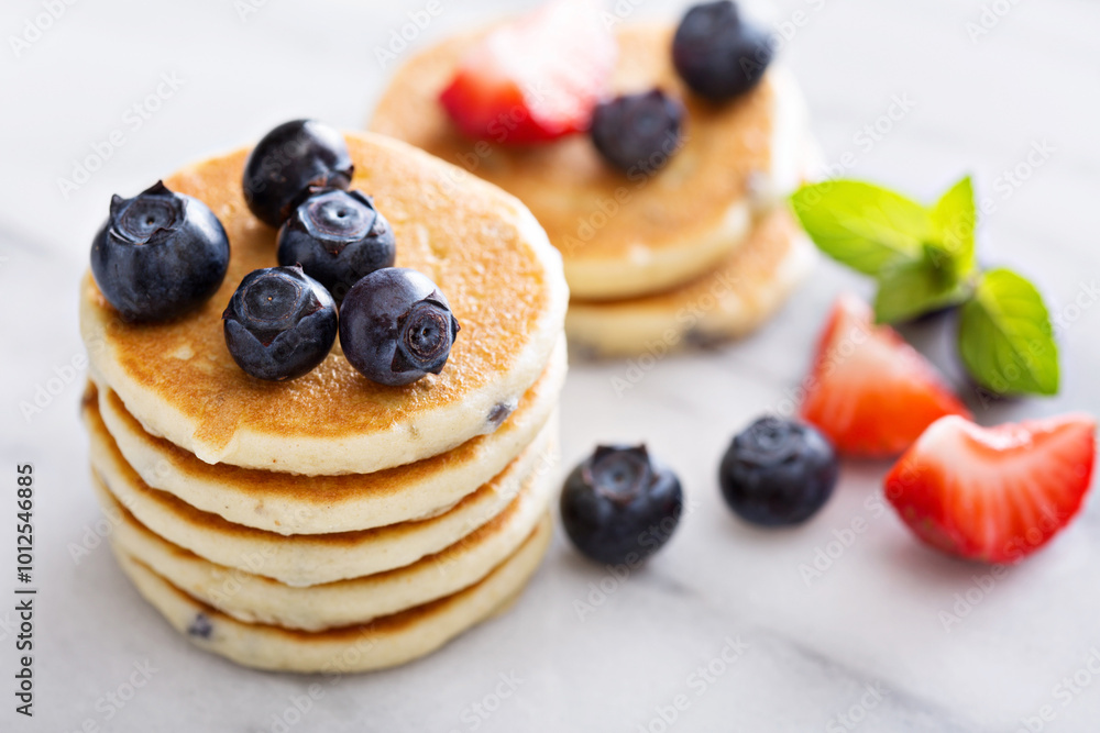 Stack of small pancakes with berries Stack of small pancakes with berries