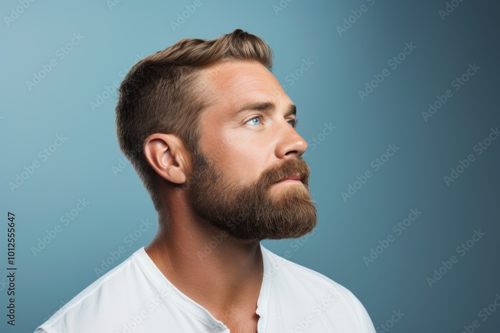 Portrait of a handsome young man with beard and mustache on blue background Portrait of a handsome young man with beard and mustache on blue background
