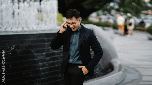 Urban Professional on the Phone: A man in a business suit takes a call on his phone in an urban setting, creating a dynamic and professional atmosphere. 