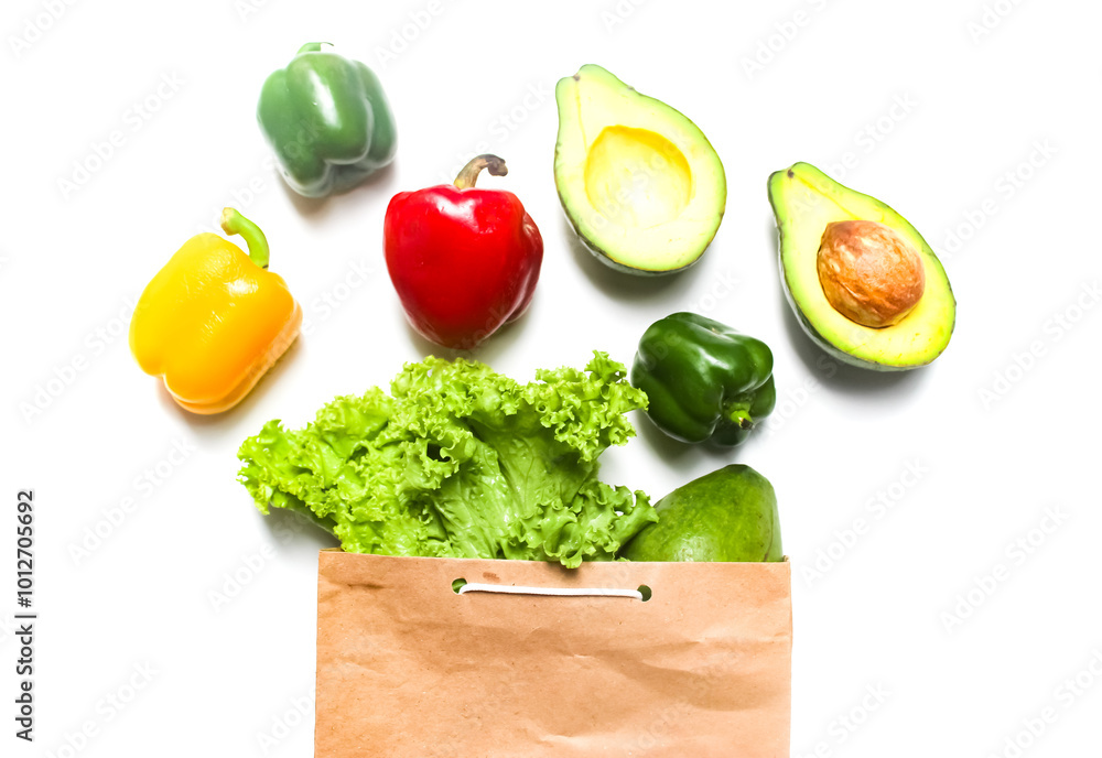 concept of fresh vegetables coming out of a paper bag, on a white background concept of fresh vegetables coming out of a paper bag, on a white background