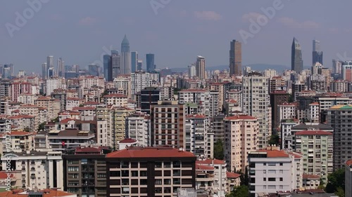 Aerial Boom Shot Above Kadikoy Neighbourhood. Istanbul Skyscrapers in Background photo