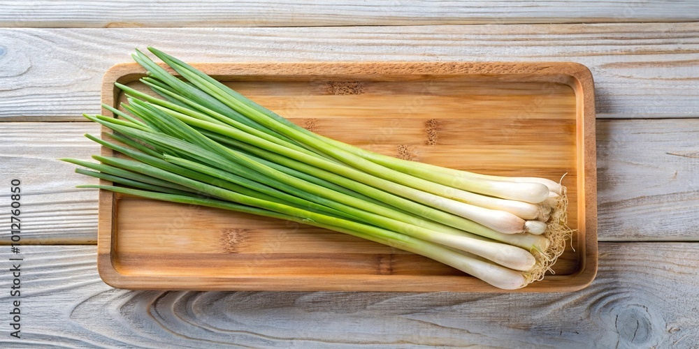 Fresh lemongrass in a wooden tray on white background aerial view Fresh lemongrass in a wooden tray on white background aerial view